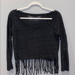 dark grey crop top with fringe on the bottom